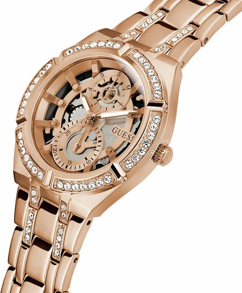 Visage cadran Guess GW0604L3 avec index cristaux scintillants, aiguilles bâton dorées et guichet date à 4h30, style squelette moderne