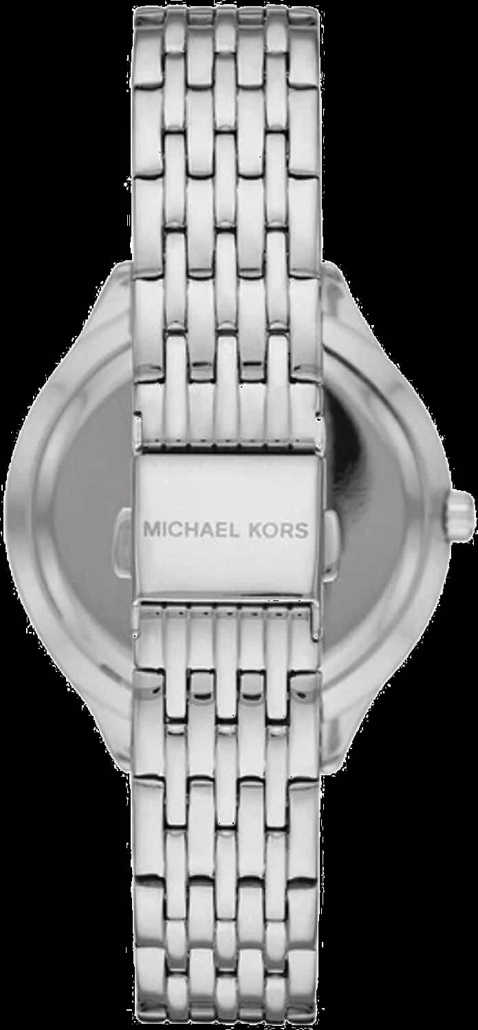 Visage cadran Michael Kors MK7075 avec aiguilles dorées facettées et index bâton sur fond soleillé