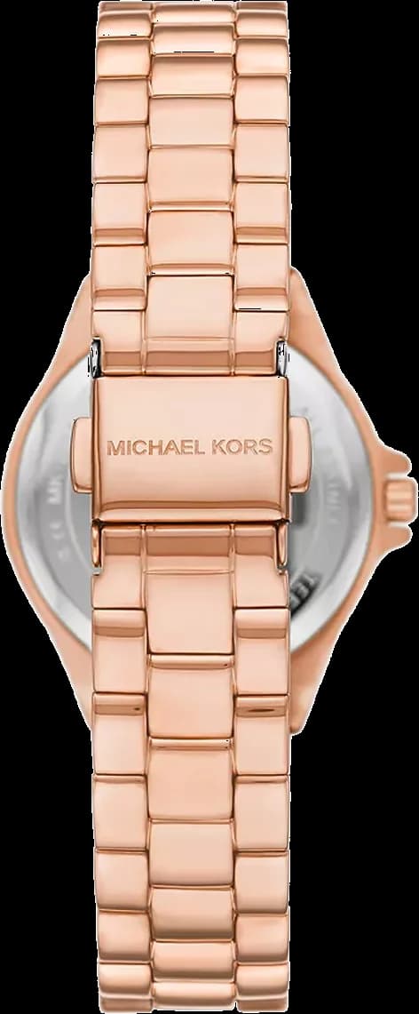 Visage cadran Michael Kors MK7396 aux index bâtons polis, aiguilles dauphine et date à 3h sur fond magenta