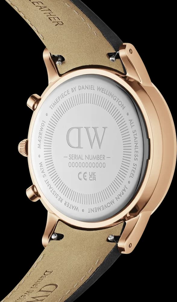 Attache bracelet Daniel Wellington DW00100646 en cuir noir grainé, boucle ardillon acier PVD or rose, coutures contrastées, 20mm de large